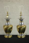 A pair of mid 20th century brass and chrome table lamps, of baluster form with circular feet. H.76