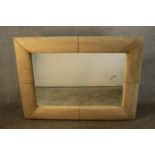 A contemporary rectangular mirror in a cream faux suede cushion frame. H.190 W.122cm