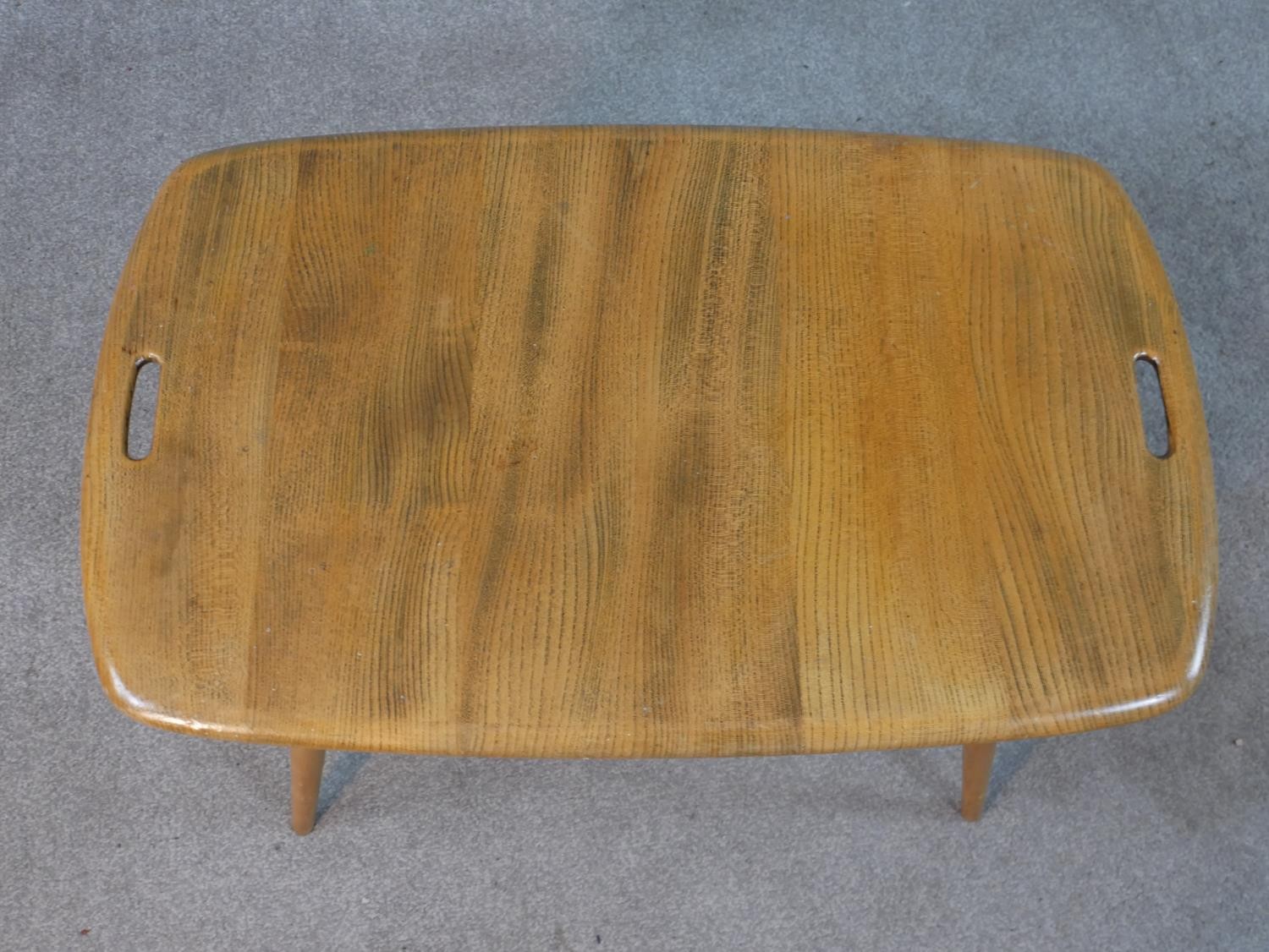 A 20th century blonde elm and beech Ercol two tier occasional tray table, model number 457, raised - Image 2 of 5