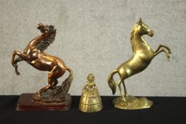 An early 20th century copper rearing horse on a mahogany base along with another brass rearing horse