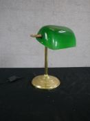 An Edwardian style brass banker's desk lamp, with an adjustable green glass shade on a reeded stem