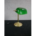 An Edwardian style brass banker's desk lamp, with an adjustable green glass shade on a reeded stem