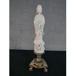 A Chinese porcelain Blanc de Chine figure of Guan Yin standing on pierced silver plated stand raised