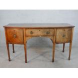A Regency mahogany bowfront sideboard; with central drawer flanked by two cupboards; raised on