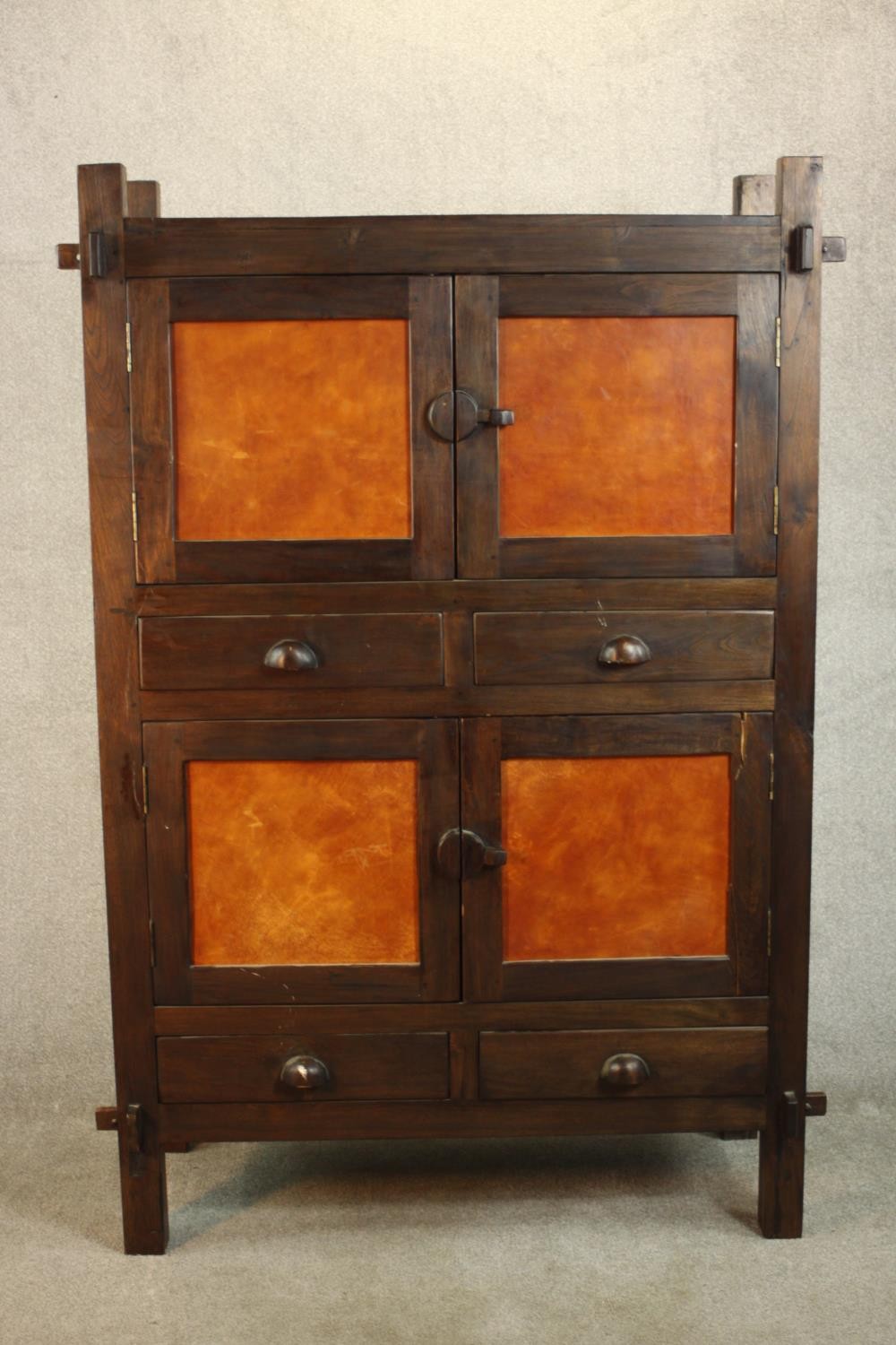 A contemporary Japanese inspired elm cabinet, with two cupboard doors enclosing a shelf over two