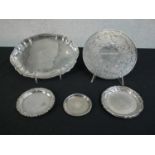 A collection of silver plate trays and place mats along with an engraved Danish silver mint tray