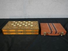 A contemporary Eastern style inlaid fold over backgammon set, together with a contemporary leather