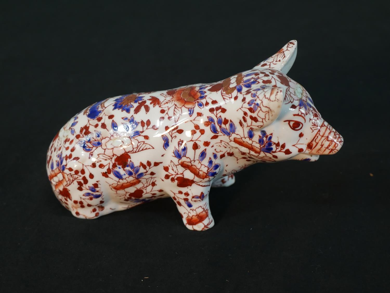 A modern Chinese porcelain pig in the Japanese Imari palette, with a four character mark to the