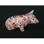 A modern Chinese porcelain pig in the Japanese Imari palette, with a four character mark to the