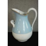 A Russian Kuznetsov porcelain wash jug, with a gilt rim, much of the body painted light blue. H.39