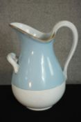 A Russian Kuznetsov porcelain wash jug, with a gilt rim, much of the body painted light blue. H.39