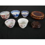 A collection of five 19th century Chinese tea bowls along with two carved and pierced hardwood