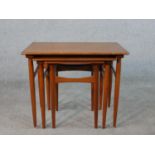 A set of three mid 20th century Danish teak intersliding tables raised on square tapering