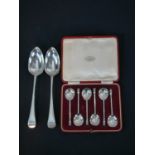 A pair of George III hallmarked silver table spoons; London 1802; 122g gross weight, 23cm long,