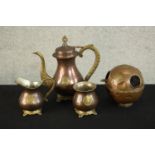 A three piece Indian brass and copper tea set with matching ashtray with relief lion boss detailing.
