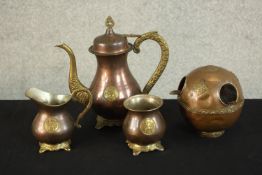 A three piece Indian brass and copper tea set with matching ashtray with relief lion boss detailing.