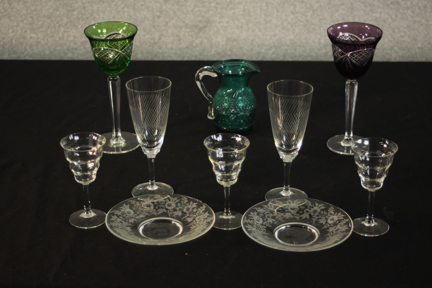 A collection of cut glass, including two Bohemian cut to clear green and purple wine glasses, two