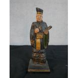 A 19th century carved painted hardwood Japanese figure of a male scholar. H.37 W.11.5 D.11.5cm