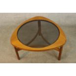 Nathan Furniture, a circa 1960s teak coffee table, with a circular smoked glass top on three