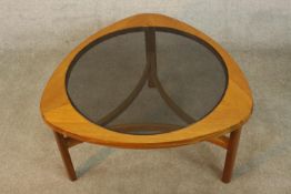 Nathan Furniture, a circa 1960s teak coffee table, with a circular smoked glass top on three