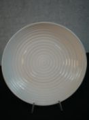 A white glazed bowl by Simon Moore, decorated with concentric circles. Diam.35cm