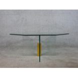 A contemporary octagonal coffee table, the plate glass top with a bevelled edge on a cross form