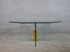 A contemporary octagonal coffee table, the plate glass top with a bevelled edge on a cross form