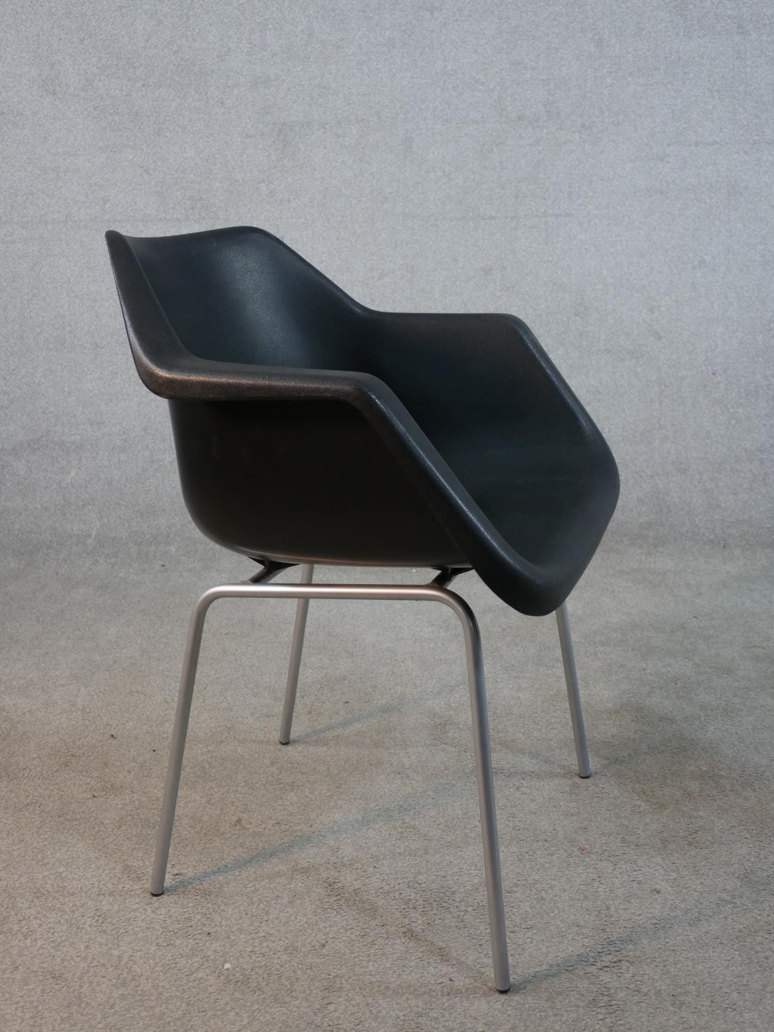 A Robin Day for Hille black plastic tub chair raised on four chrome plated outswept supports, - Image 4 of 5