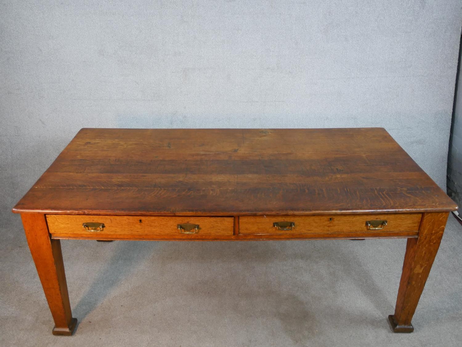 An early 20th century oak two drawer writing table raised on tapering supports terminating in square - Image 5 of 6