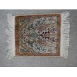 A cream ground hand made Persian silk Kum rug. W.33 D.28cm
