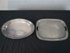 A hammered pewter twin handled tray with another oval silver plated. H.36 W.47cm Largest