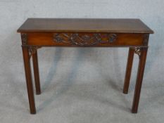 A George II mahogany side table, of rectangular form, with an end drawer, the frieze with applied