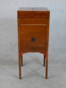 A George III crossbanded mahogany foldout washstand with single door and drawer raised on square