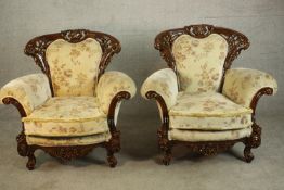 A pair of late 20th century carved and lacquered armchairs, upholstered in cream coloured foliate