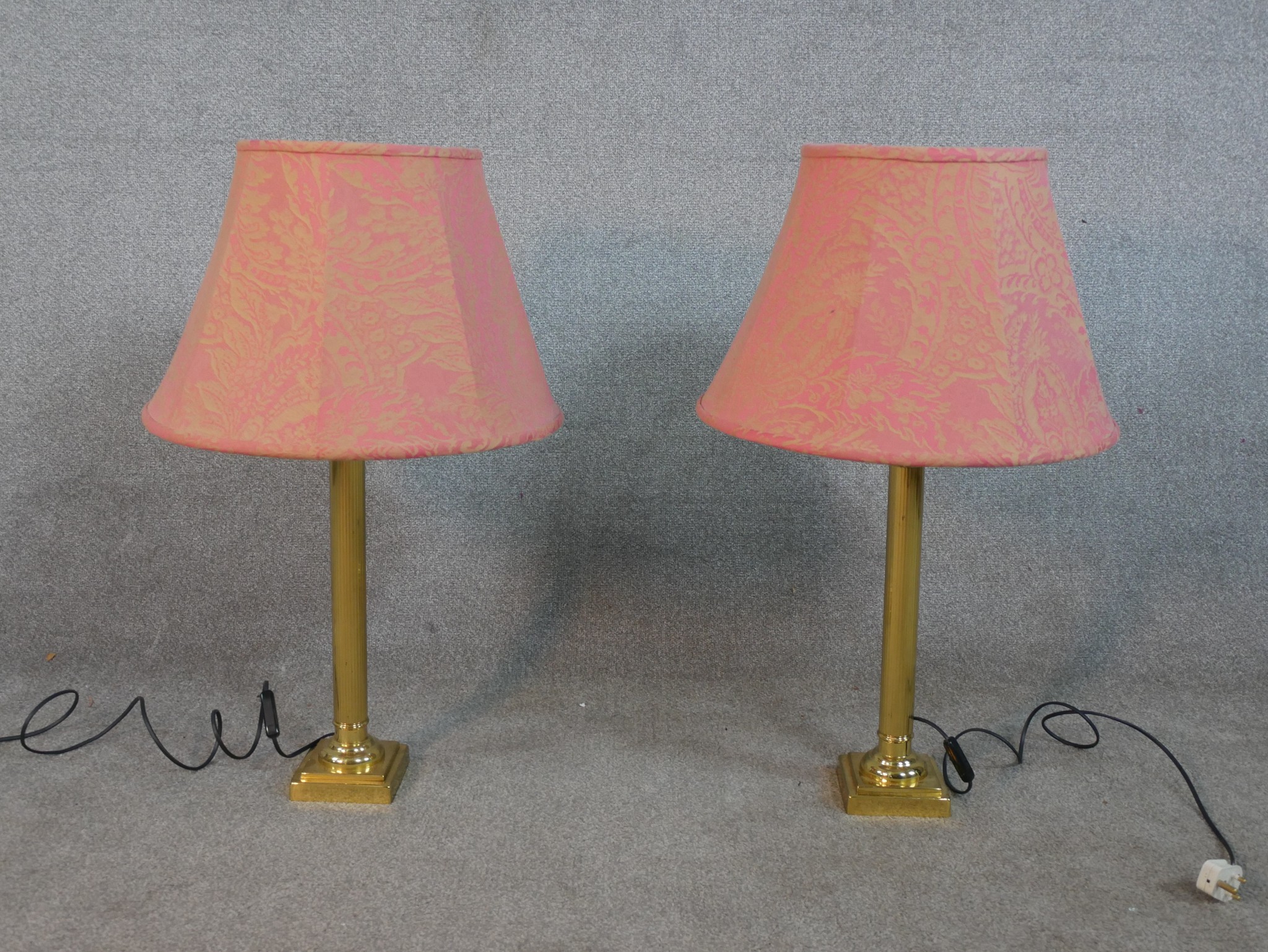 A pair of late 20th century brass table lamps in the form of Corinthian columns, on square step down