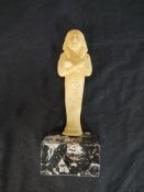 Egyptian style sandstone figure raised on plinth base, together with a terracotta Egyptian canopic