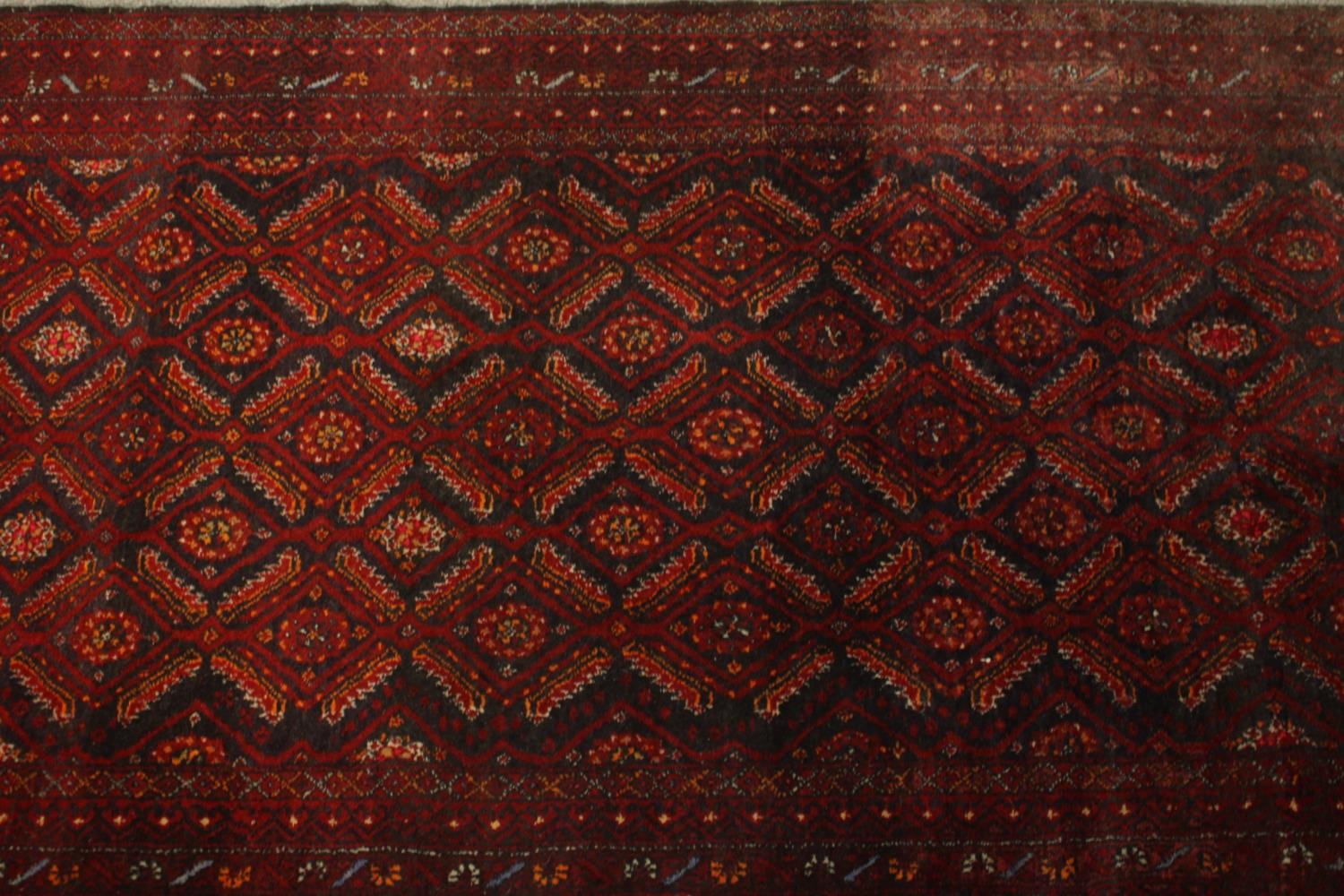 A red ground Baluch rug with all over geometric pattern. L.190 W.88cm. - Image 3 of 6