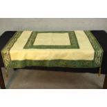 A silk embroidered table cloth/runner with tassels to the corners. L.122 W.124cm.