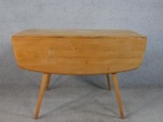 A 20th century Ercol elm top drop flap table, model 383, raised on four splayed tapering supports,