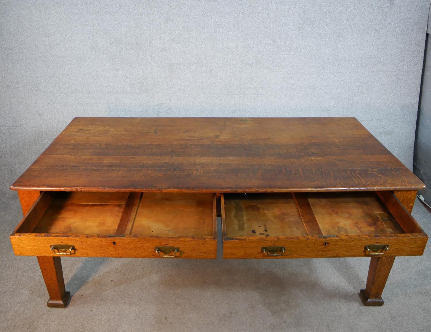 An early 20th century oak two drawer writing table raised on tapering supports terminating in square - Image 4 of 6
