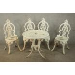 A Victorian style white painted wrought iron garden set comprising of matching four chairs and a