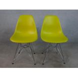 A pair of yellow plastic Charles Eames DSR side chairs, designed by Charles and Ray Eames in 1950