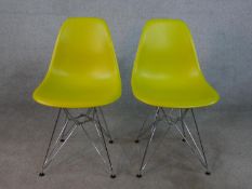 A pair of yellow plastic Charles Eames DSR side chairs, designed by Charles and Ray Eames in 1950