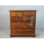 A Victorian oak chest, with panelled sides, having two short over three long graduated drawers on