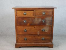 A Victorian oak chest, with panelled sides, having two short over three long graduated drawers on