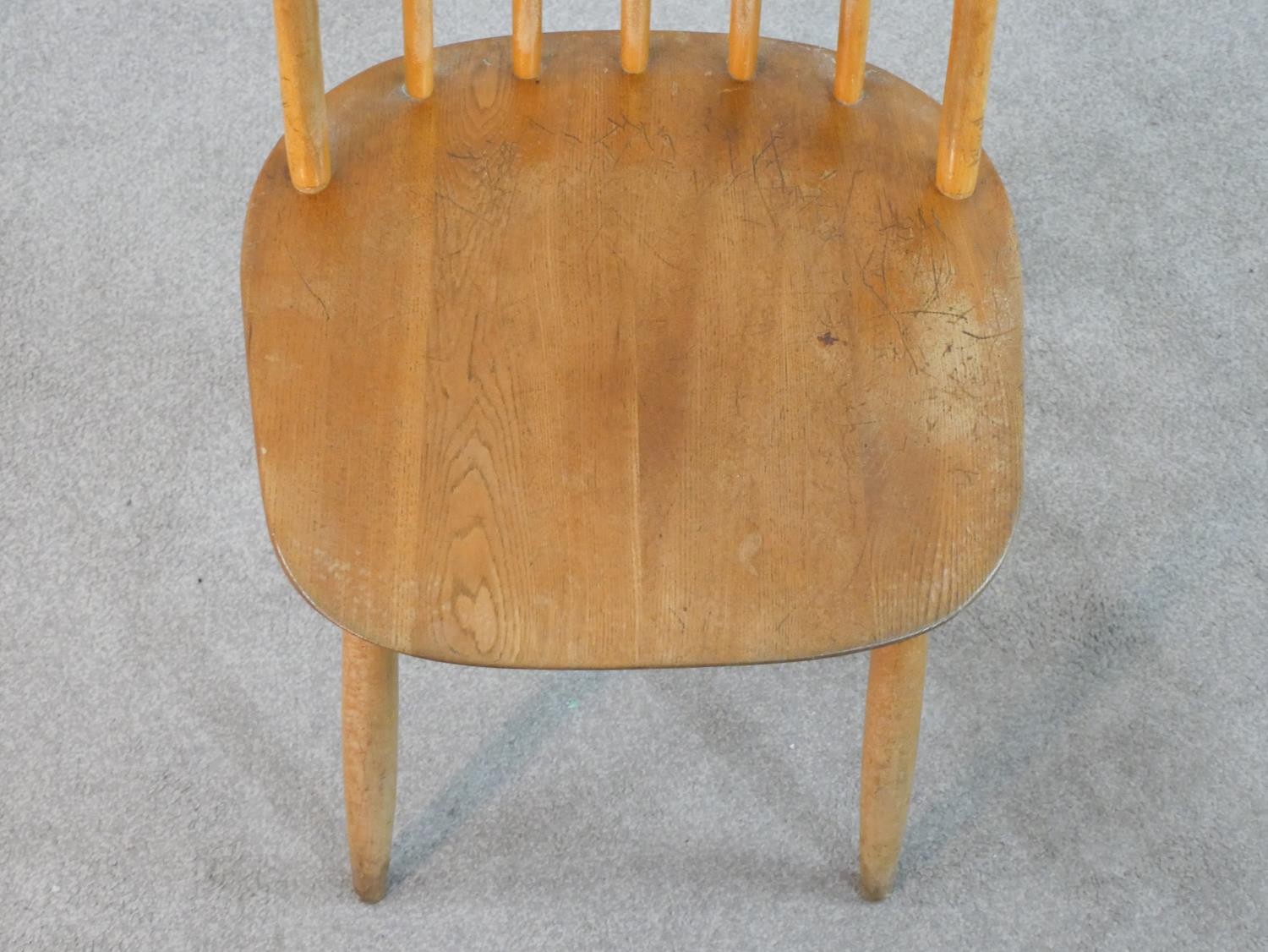A set of four 20th century Ercol style blond elm hoop back Windsor dining chairs. - Image 5 of 6