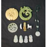 Assorted carved Chinese jade items to include a pendant, translucent jade roundel, a jade dragon