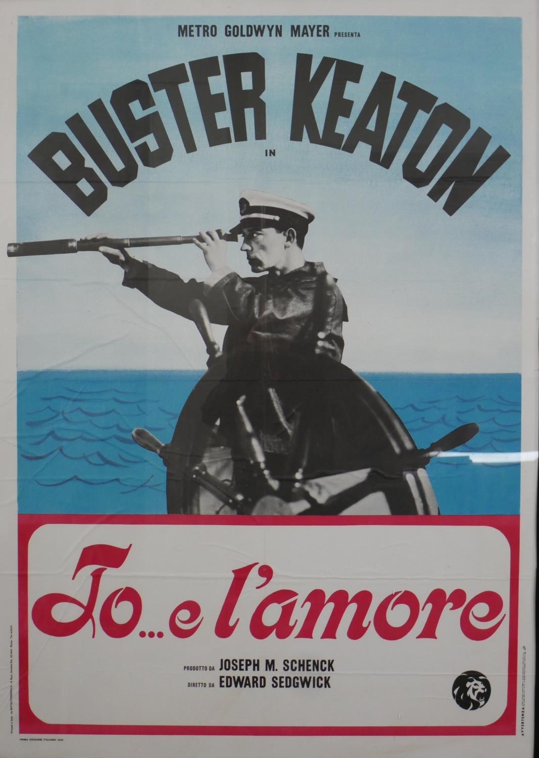 A framed reproduction coloured filmed poster, Buster Keaton El'Amore. H.147.5 W.108cm
