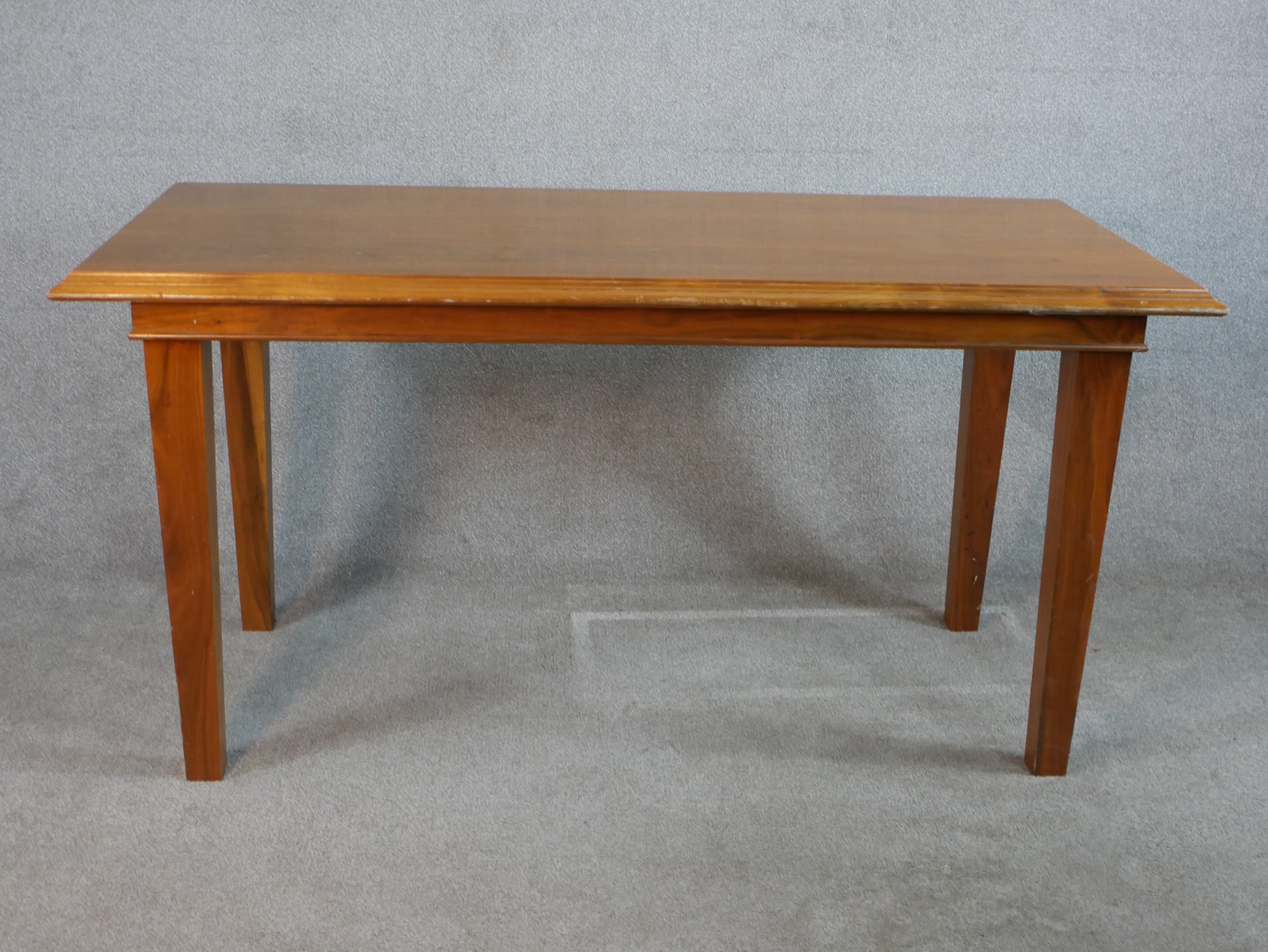 A mid 20th century walnut table raised on tapering supports. H.76 W.151 D.71cm