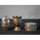 An Indian silver / white metal oval box and cover decorated with Gods, together with an Indian white